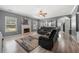 Bright living room features a fireplace, hardwood floors, and modern furniture at 143 Monarch Way, Hiram, GA 30141