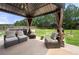 Backyard patio sitting area with comfortable furniture, a grill, and ample space for entertaining guests at 143 Monarch Way, Hiram, GA 30141