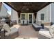 Covered patio with comfortable seating, a stone fireplace, and a grill, perfect for relaxing and entertaining at 143 Monarch Way, Hiram, GA 30141