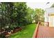 View of large backyard and side of house from back deck at 1601 Haven Crest Ct, Powder Springs, GA 30127