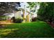 Expansive backyard featuring a well-maintained lawn and mature trees, perfect for outdoor activities at 1601 Haven Crest Ct, Powder Springs, GA 30127