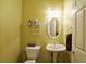 This bathroom features a pedestal sink, oval mirror, and convenient shelving at 1601 Haven Crest Ct, Powder Springs, GA 30127
