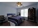 Cozy bedroom with a ceiling fan, window, and dark wood dresser at 1601 Haven Crest Ct, Powder Springs, GA 30127