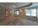 Large room with natural light from two windows, tray ceiling, recessed lights awaiting renovation at 1601 Haven Crest Ct, Powder Springs, GA 30127