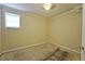 Small bedroom featuring a single window, neutral walls, and awaiting new flooring at 1601 Haven Crest Ct, Powder Springs, GA 30127