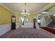 Spacious dining area with chandelier, trim detail and entry to staircase and multiple rooms at 1601 Haven Crest Ct, Powder Springs, GA 30127