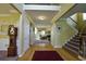 Inviting foyer with hardwood floors, a staircase, and view into the living room at 1601 Haven Crest Ct, Powder Springs, GA 30127
