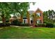 Inviting red brick home with a bay window, lush landscaping, and a well-maintained front lawn at 1601 Haven Crest Ct, Powder Springs, GA 30127