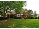 Inviting red brick home with a bay window, lush landscaping, and a well-maintained front lawn at 1601 Haven Crest Ct, Powder Springs, GA 30127