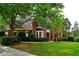 Charming red brick home with a bay window, lush landscaping, and a well-maintained front lawn at 1601 Haven Crest Ct, Powder Springs, GA 30127