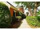 Landscaped front yard featuring lush greenery, a sidewalk, and a charming brick facade at 1601 Haven Crest Ct, Powder Springs, GA 30127