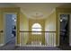 A hallway with decorative iron railing overlooks the front entry through arched window at 1601 Haven Crest Ct, Powder Springs, GA 30127