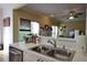 Kitchen sink with stainless steel faucet and view into living room at 1601 Haven Crest Ct, Powder Springs, GA 30127