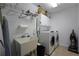 Functional laundry room with sink, washer, dryer, and storage cabinets at 1601 Haven Crest Ct, Powder Springs, GA 30127