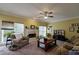 Cozy living room featuring a fireplace, large windows, carpet, and comfortable furniture at 1601 Haven Crest Ct, Powder Springs, GA 30127