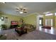 Spacious living room featuring carpet, large windows, modern TV, and plush sofa at 1601 Haven Crest Ct, Powder Springs, GA 30127