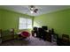 Lime-green office space featuring a window, ceiling fan, and ample desk space at 1601 Haven Crest Ct, Powder Springs, GA 30127