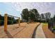 Community playground with swings, slides, and ample room to play at 1601 Haven Crest Ct, Powder Springs, GA 30127