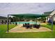 Poolside seating area with shade cover and ample chair and table seating, with a full community pool at 1601 Haven Crest Ct, Powder Springs, GA 30127