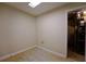 Empty, simple room with tile floor, painted walls and doorway leading to the unfinished space at 1601 Haven Crest Ct, Powder Springs, GA 30127