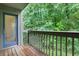 Balcony featuring a wooden deck overlooking lush greenery with a glass door at 206 Tuxworth Cir, Decatur, GA 30033