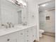 Bright bathroom featuring a double sink vanity and glass enclosed shower at 206 Tuxworth Cir, Decatur, GA 30033