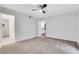 Bedroom featuring neutral carpet, white walls, and access to the bathroom and closet at 206 Tuxworth Cir, Decatur, GA 30033