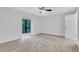 Bright bedroom with a large window, plush carpet, ceiling fan, and a neutral color palette at 206 Tuxworth Cir, Decatur, GA 30033