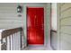 Inviting red front door with sidelight and elegant exterior lighting fixture at 206 Tuxworth Cir, Decatur, GA 30033