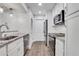 Well-lit kitchen with granite countertops, stainless steel appliances, and wood floors at 206 Tuxworth Cir, Decatur, GA 30033