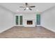 Spacious living room with wood floors, ceiling fan, fireplace, and glass doors at 206 Tuxworth Cir, Decatur, GA 30033