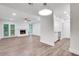 Bright living room with fireplace, wood floors, and view of the kitchen at 206 Tuxworth Cir, Decatur, GA 30033