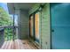 Outdoor patio with wood floor, railing, sliding glass door, and serene views at 206 Tuxworth Cir, Decatur, GA 30033
