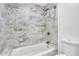 Bathroom featuring a marble-tiled shower with a tub and a mounted shower head at 206 Tuxworth Cir, Decatur, GA 30033