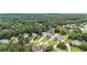 Overhead view shows a neighborhood surrounded by lush greenery and mature trees, with well-spaced homes at 224 Mountain View Dr, Woodstock, GA 30188