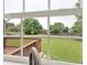 A view of a well-maintained backyard through a kitchen window, showcasing a deck and green lawn at 224 Mountain View Dr, Woodstock, GA 30188