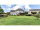 Large backyard featuring a well-manicured lawn, mature trees, and a screened-in porch at 224 Mountain View Dr, Woodstock, GA 30188