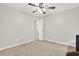 Bedroom featuring neutral walls, carpet, a ceiling fan, and white doors at 224 Mountain View Dr, Woodstock, GA 30188