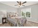 Bright bedroom with a bed, nightstand, windows, and a ceiling fan at 224 Mountain View Dr, Woodstock, GA 30188