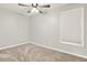 Neutral bedroom with a ceiling fan, soft carpet, and a window at 224 Mountain View Dr, Woodstock, GA 30188