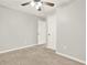 Bright bedroom featuring neutral walls, carpet, ceiling fan and white doors at 224 Mountain View Dr, Woodstock, GA 30188