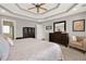 Bedroom featuring tray ceiling, large window, ceiling fan, and dresser at 224 Mountain View Dr, Woodstock, GA 30188