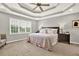 Spacious bedroom with tray ceiling, large window, ceiling fan, and neutral decor at 224 Mountain View Dr, Woodstock, GA 30188