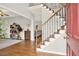 Inviting entryway featuring hardwood floors, staircase with wooden railing, and a view into the living area at 224 Mountain View Dr, Woodstock, GA 30188