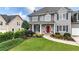 A well-maintained home with professional landscaping, green lawn, and a charming red front door at 224 Mountain View Dr, Woodstock, GA 30188