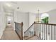 Bright hallway with stairs and natural light from the large arched window at 224 Mountain View Dr, Woodstock, GA 30188