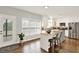 Bright and open kitchen featuring white cabinets, a stainless steel refrigerator, and a central island with bar seating at 224 Mountain View Dr, Woodstock, GA 30188
