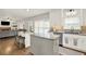 Inviting kitchen boasts an open design, white cabinetry, granite countertops, and seamlessly connects to the living area at 224 Mountain View Dr, Woodstock, GA 30188