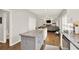 Spacious kitchen open to the living room, featuring white cabinets, granite counters, and hardwood flooring at 224 Mountain View Dr, Woodstock, GA 30188