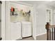 Convenient laundry room featuring modern appliances and storage shelves at 224 Mountain View Dr, Woodstock, GA 30188